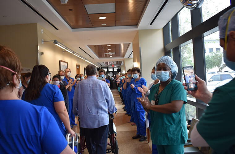 Patient walks out to cheers from hospital staff
