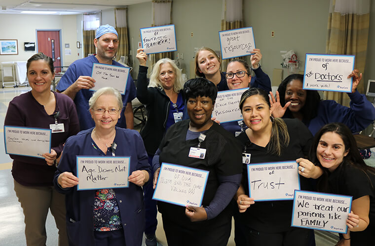 Group of BayCare team members holding testimonial signs