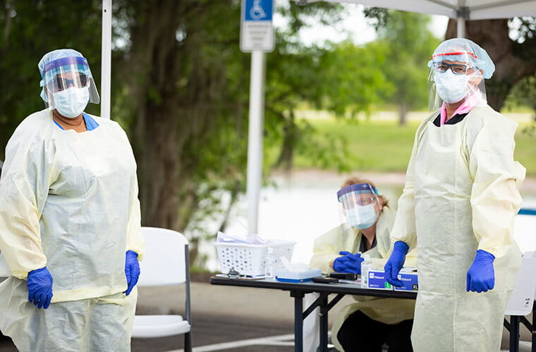 Group of medical professionals working at a covid drive through testing center