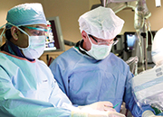 Alok Singh, M.D., (left) and Andrew Sherman, M.D., collaborate during a cardiac procedure. Dr. Singh is Chair of St. Joseph's Hospital's Cardiology program and Dr. Sherman is Chair of St. Joseph's Hospital's Cardiovascular Surgery program