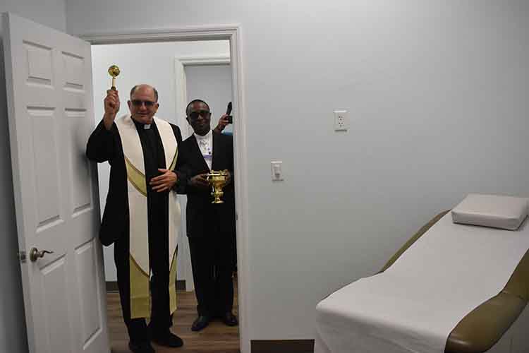 Priests bless an exam room at La Esperanza