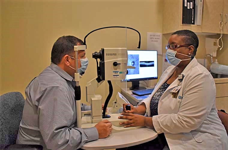 Man sitting with clinician during ARIAS Alzheimer's screening