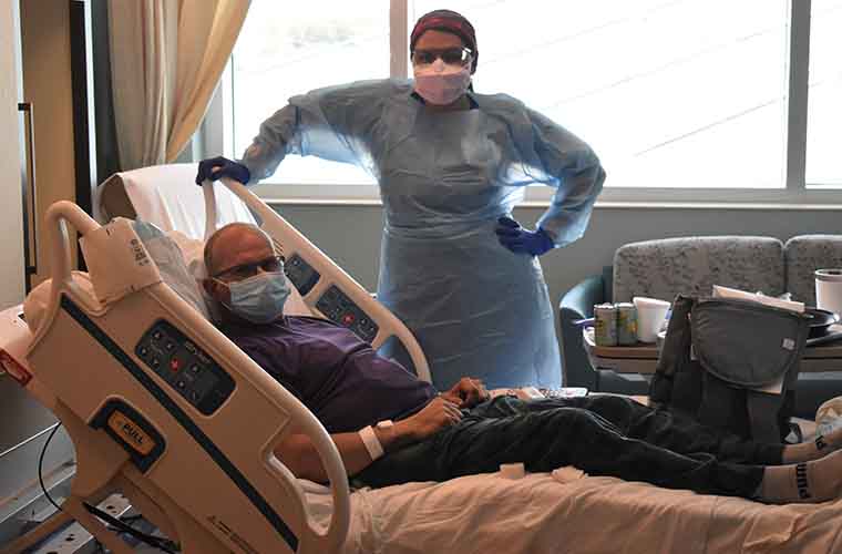 Mark Metzger and nurse Alexis Lastres in his room at St. Joseph's Hospital-North