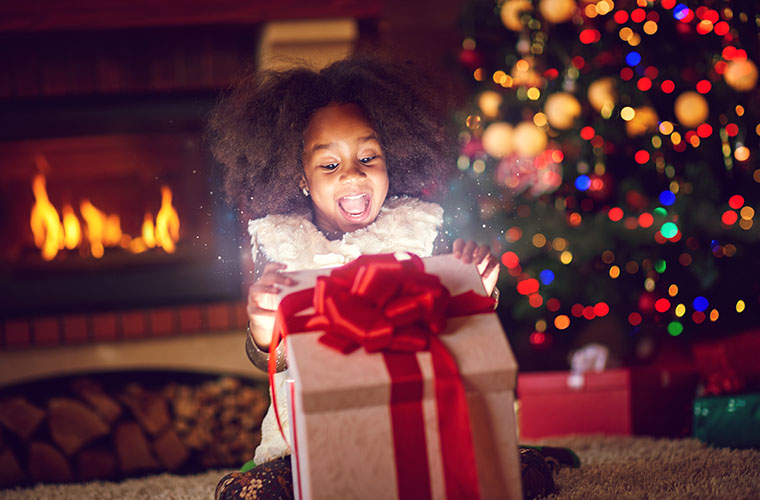 Child opens present on Christmas morning