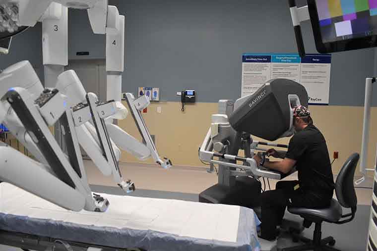 Dr. Brett Armstrong at the robot's console demonstrating how the robot is guided by the surgeon.