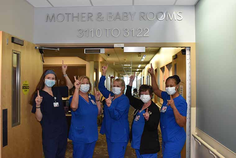 Some members of the Mom & Baby unit celebrate with the #1 symbol