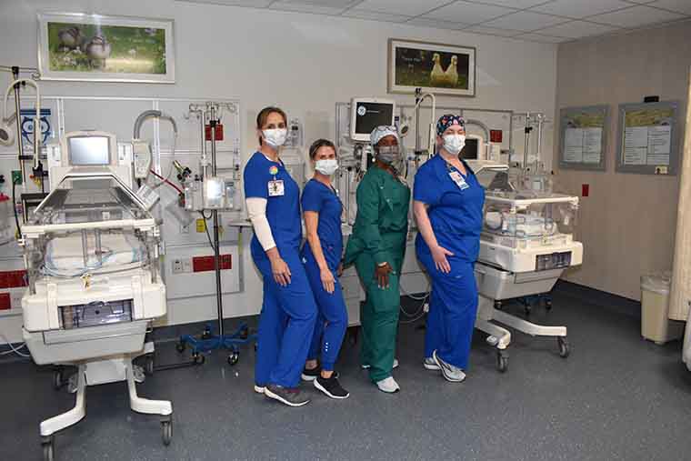 Some team members in a NICU room.