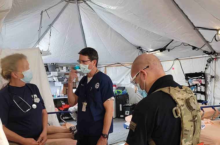 Jack with teammates in a DMAT tent