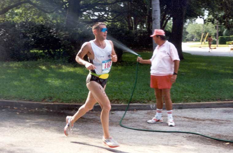 In 1991, a good neighbor to the St. Anthony’s Triathlon refreshes athletes buy spraying them with water from a personal hose.  