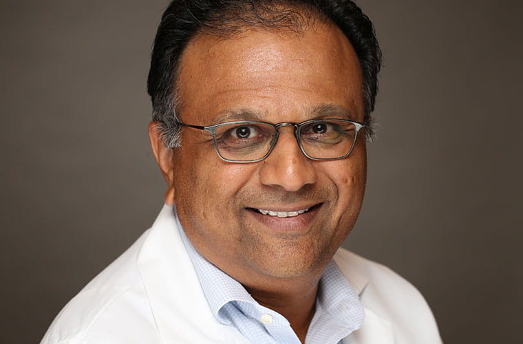 Headshot of Dr. Mahesh Amin wearing a white physician's coat.