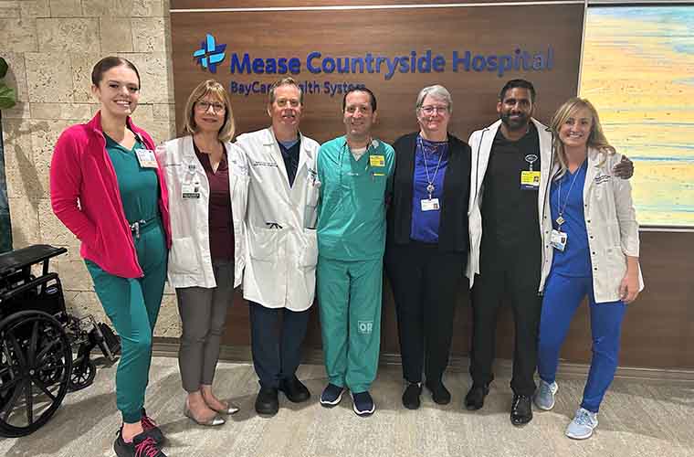 One patient and six members of the Mease Countryside bariatric team gather for a photo in the hospital’s lobby.