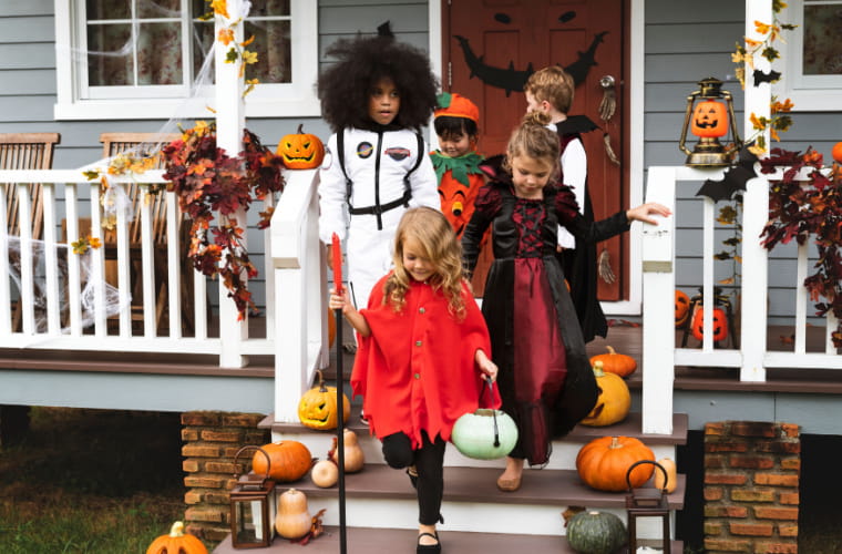 Little children trick or treating on Halloween.