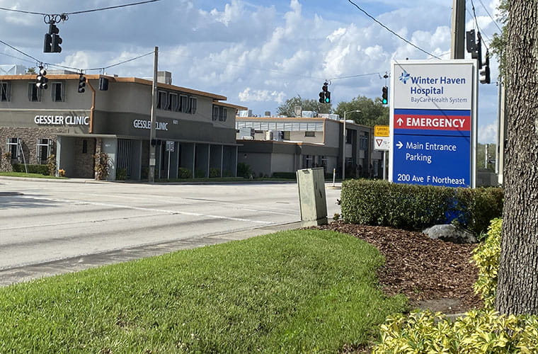 A medical clinic shown across the street from a hospital.