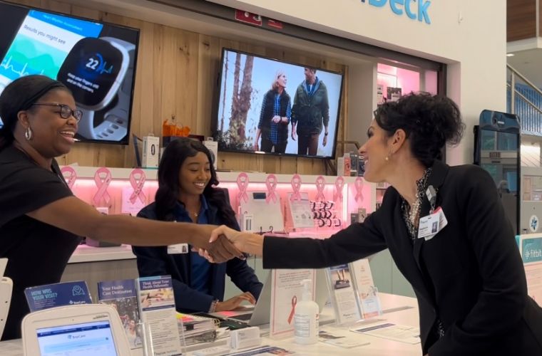 CEO of health care organization shaking a team member's hand.