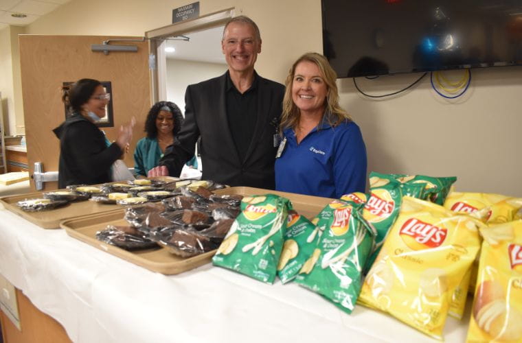 Two hospital administrators pose for a photo.