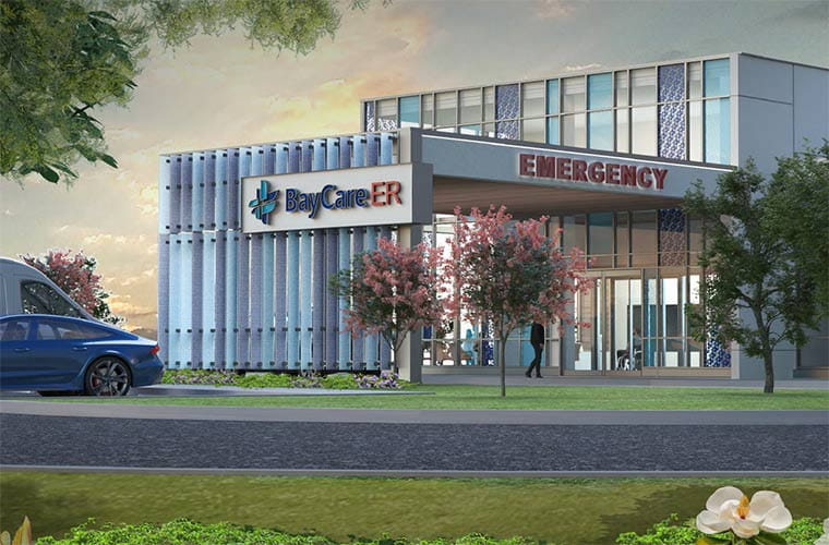 An artist's rendering depicts a two-story building with floor-to-ceiling windows, of varying clarity and color patterns. An awning reaches toward the foreground, with  signage displaying the words "EMERGENCY" and "BayCare ER." A sunset sky and green foliage can be seen in the background and foreground, respectively.