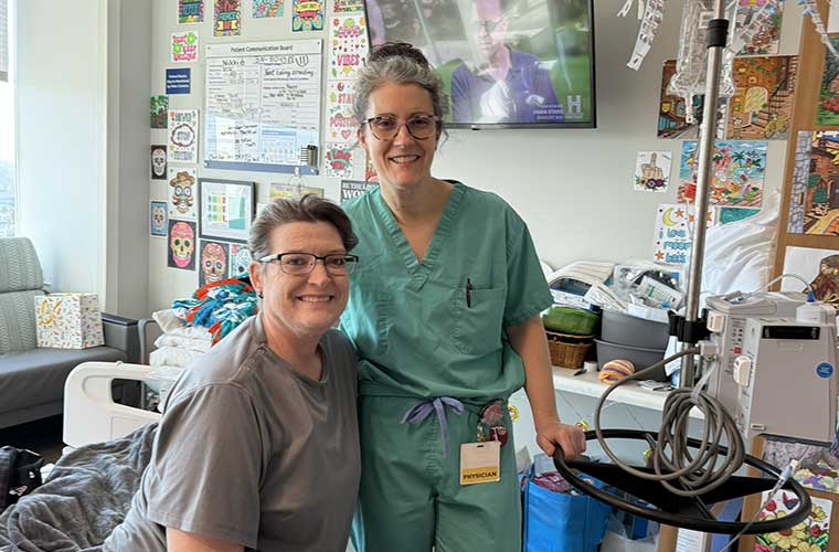 Nikki Reed, sitting, with Elizabeth Myers, DO, in the room that became Nikki's home for nearly a year at St. Joseph's Hospital.