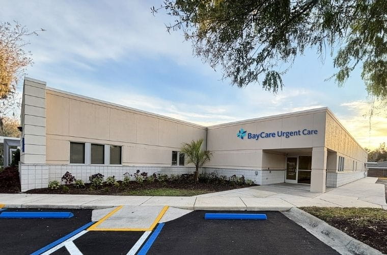 Exterior of BayCare Urgent Care (Plant City) showing the building entrance, signage, sidewalk and parking area on a clear day.