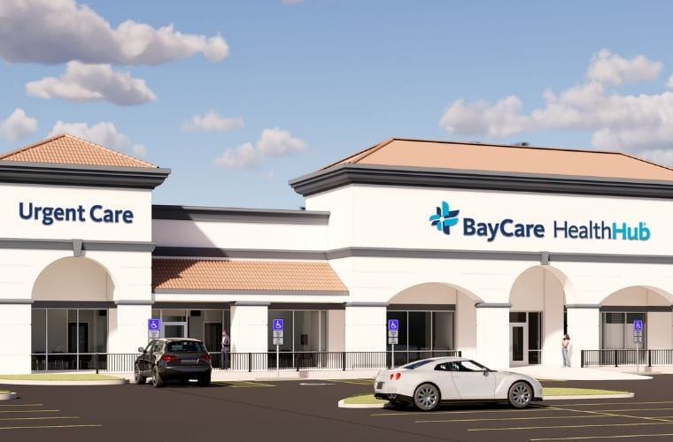 Exterior of BayCare HealthHub (Carrollwood) with Urgent Care entrance, parking spaces and BayCare HealthHub signage.