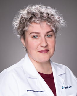 Dr. LaBeaud's headshot wearing a labcoat 