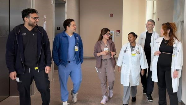 Doctors, residents and staff walking in the hall together 