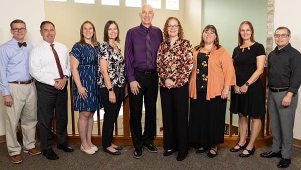 Group photo of MPM faculty standing in a line