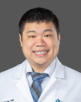 Dr. Daniel Lee's Headshot wearing a lab coat 