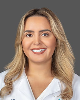 Dr. Lilian Fornos' headshot wearing a lab coat 