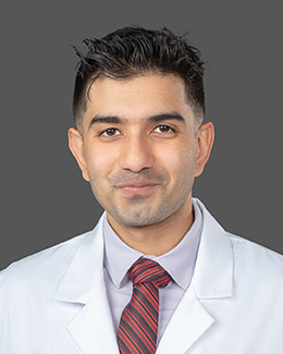 Dr. Oneeb Tahir's headshot wearing a lab coat 