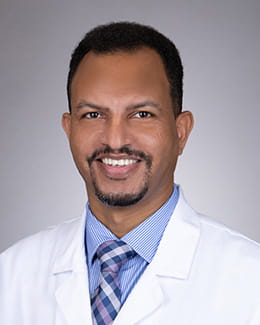Headshot of Abraham Isaak, MD, MSc in a lab coat