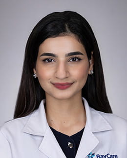 Headshot of Munahal Nasim, MD in a lab coat