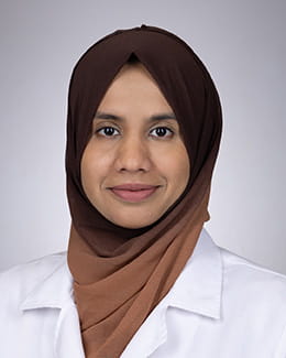 Headshot of Yumna Hasan, MD in a lab coat