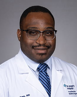 Kamso Okonkwo's headshot in a lab coat