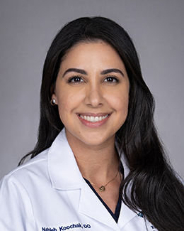 Nahloeh Koochak's headshot in a lab coat