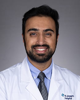Pranit Singh's headshot in a labcoat
