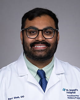 Ravi Shah headshot in a lab coat 