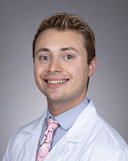 Steven Siena's headshot in a lab coat