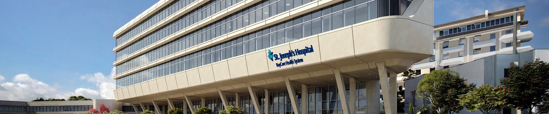 st. joseph's hospital's new tower, exterior view of a large building with a blue text sign.jpg