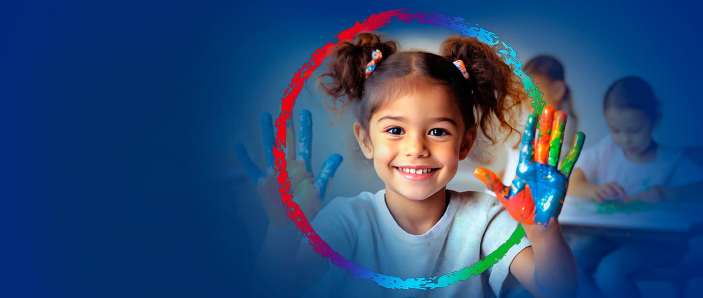 A young girl in a classroom setting smiling with paint on her hands, surrounded by the BayCare Effect logo