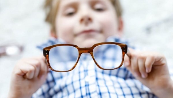 Boy holding eye glasses