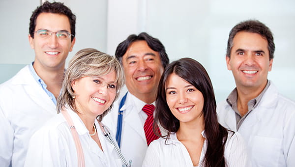 A smiling group of male and female doctors