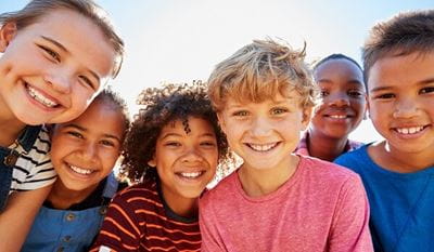 A group of diverse and happy girls and boys