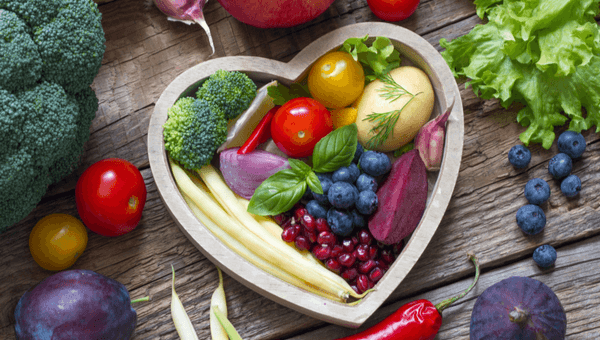 a bowl of fruit in the shape of a heart