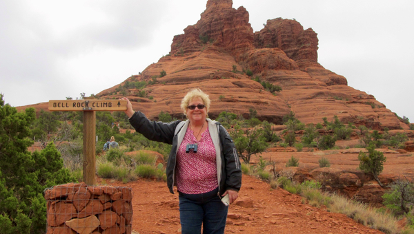 woman standing in front of desert mountain