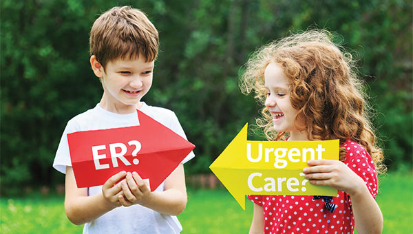 A boy holds an arrow-shaped sign that says "ER?" while standing next to a girl who is holding a sign that says "Urgent Care?"