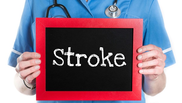 medical professional holding a sign that says stroke