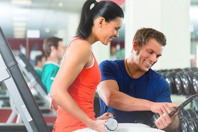 Personal trainer helping his client