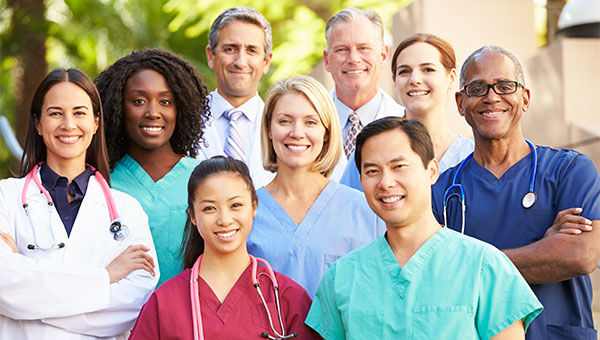 A smiling group of male and female doctors and nurses