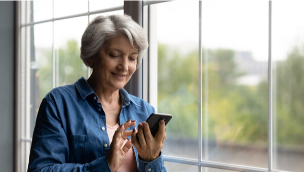 a woman looking at her phone and smiling