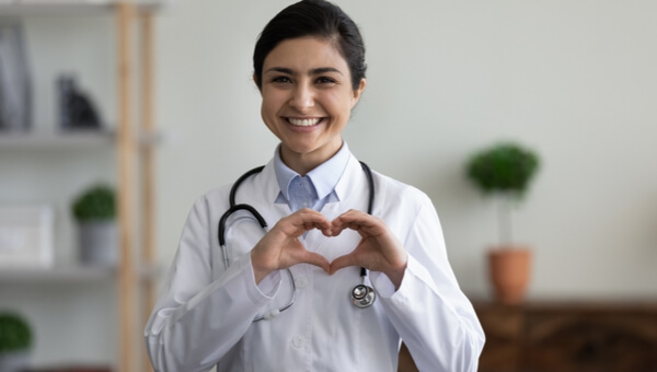 a doctor making a heart shape with her hands
